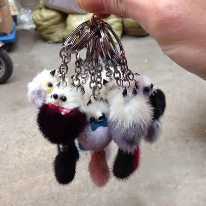 Fur pom keychain held in hand for size